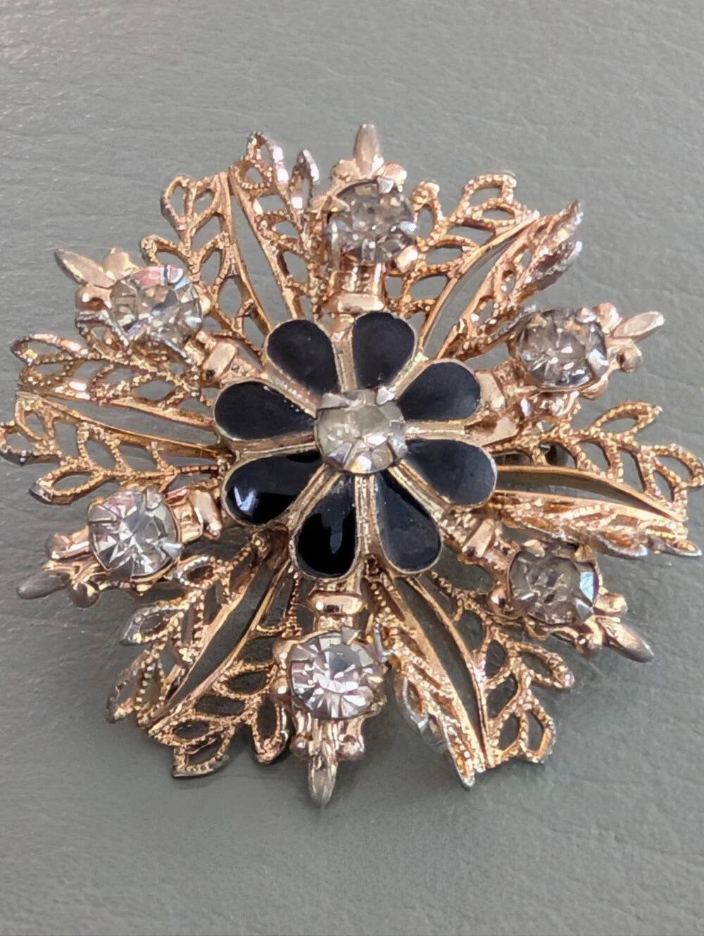 Gold-Tone Filigree Floral Starburst Brooch with Black Enamel and Clear Crystals